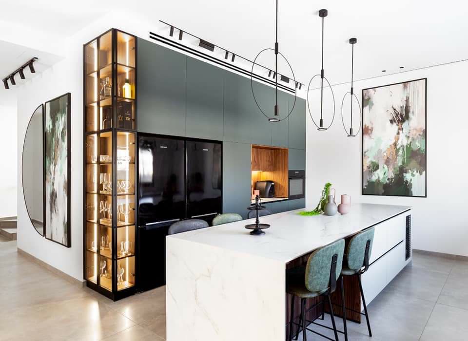 Contemporary kitchen with dark green glass-front cabinets and marble island by iKitchen Cabinetry
