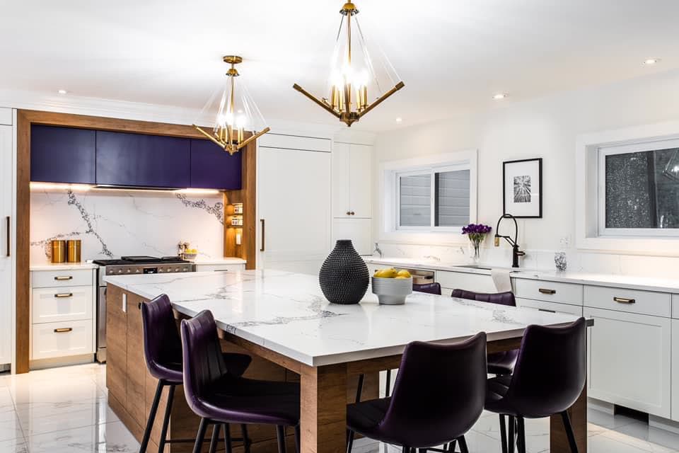 Traditional white shaker kitchen with navy island and marble counters by iKitchen Cabinetry