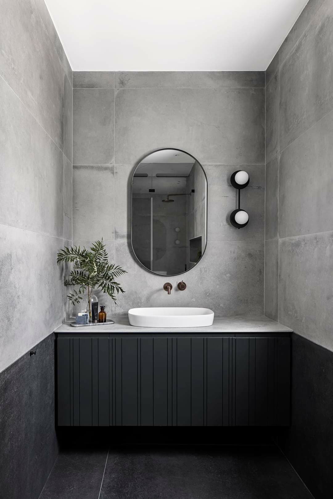 Primary bathroom vanity with drawer stacks, a center storage tower, and integrated lighting